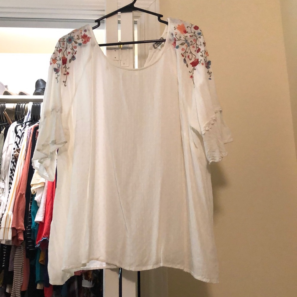 White blouse with embroidery on the sleeves
